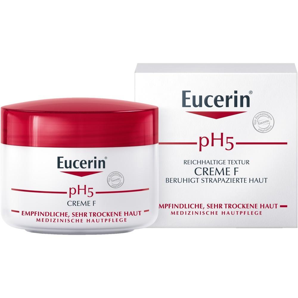 Eine weiße Creme-Dose mit rotem Deckel steht vor ihrer Verpackung.
